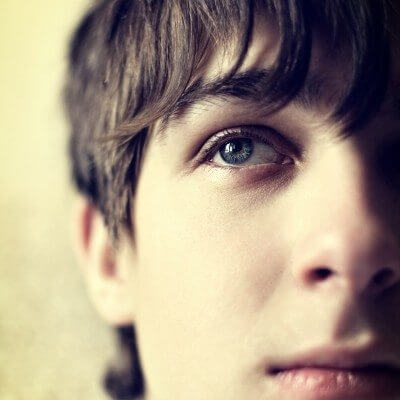 Toned Photo of Sad Teenager with anxiety Face closeup with Focus on an Eye
